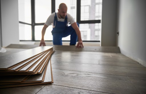 a picture of a person installing hardwood floors